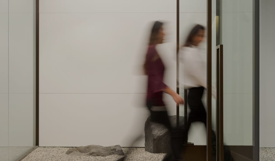 photo of two women walking into an office